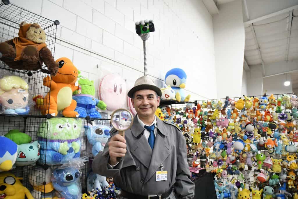 Toy plush collection at a store display with a man holding a magnifying glass.