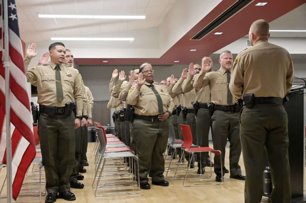 Madera County deputies taking oath during swearing-in ceremony.