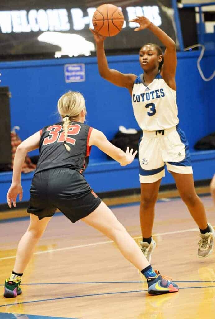 Photo - Madera’s Aasyria Goins puts up a shot over Sanger’s Mallory Scott during Tuesday’s loss to the Apaches. Goins scored 11 points, including a pair of 3-pointers.