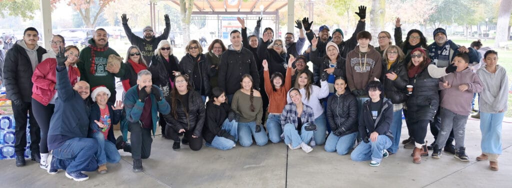 Photo of H.O.P.E. Ministry volunteers gather for a photo and show their enthusiasm during the annual Christmas Outreach Community event in Courthouse Park on Saturday.
