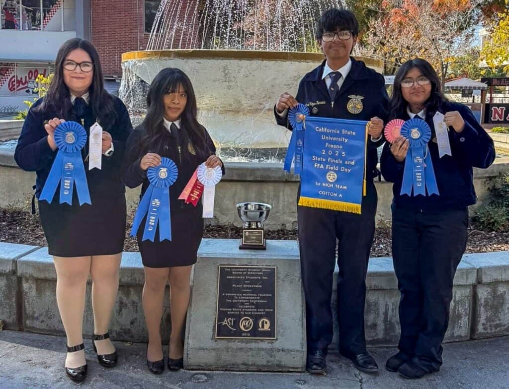 Photo - From left, Malia Rodriguez, Alma Vasquez, Manuel Reyes-Herrera, and Aracely Reyes-Herrera show off their state champion ribbons, banner and trophy after winning the Cotton Judging state competition on November 1.