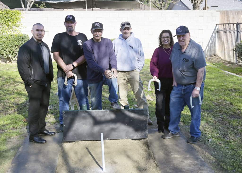 Photo of Adam Romero, left, and Olga Saucedo-Garcia from the City of Madera Parks and Community Services are joined by members of Big Valley Horseshoe League members. From second from left are Mike Jones, Bobby Chavira, Jason Longcor and Harlen Rippetoe following the completion of horseshoe pit renovations made by the league at Pan American Center on Wednesday.