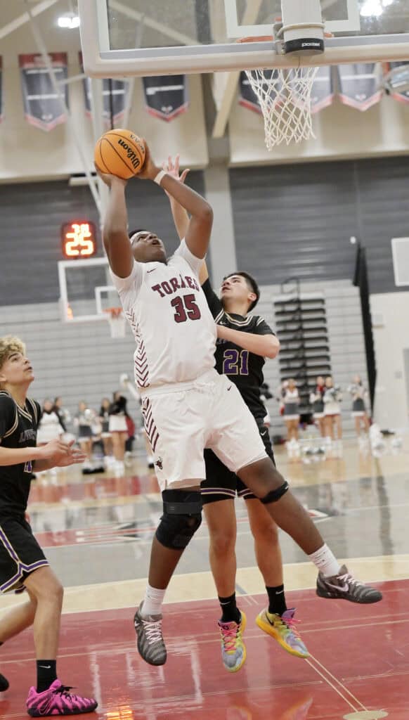 Photo of Matilda Torres’ Nate Gray puts back an offensive rebound during Thursday’s victory over Livingston. Gray finished with a double-double in his first game of the season (14 points, 13 rebounds).