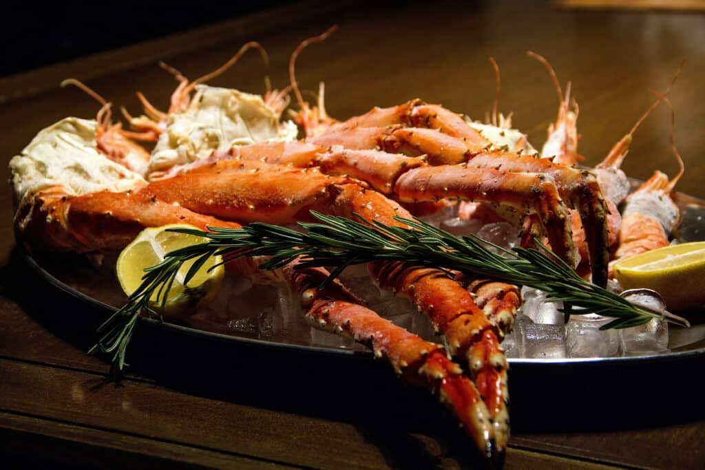 Photo provided by Seafood lovers cherish a platter of tasty crab legs. A cooked artichoke is a good go-along for such a meal.