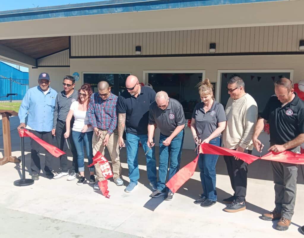 Photo of the Chowchilla Chamber of Commerce staff, City of Chowchilla officials and County dignitaries cut the ribbon on a newly-refurbished concession stand at Edward Ray Park.