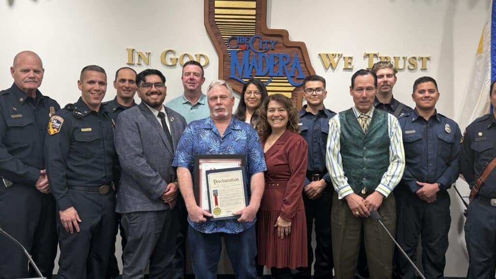 Photo of Scott Farrell, center, is honored by the Madera City Council and the California State Legislature for his more than 40 years of service with the Madera Fire Department and later the California Department of Forestry (CDF) at Madera City Hall on March 4. Scott is shown with his fellow firefighters from CDF, Madera City Council members, and representative from the state Legislature.