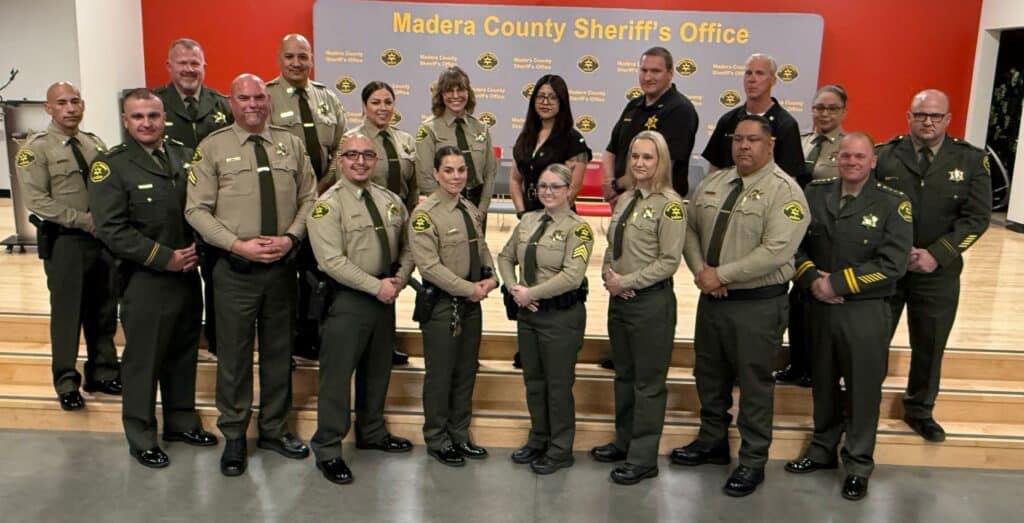 Photo - The Madera County Sheriff’s Office hosts a Swearing-in Promotions and Awards Ceremony last week at Matilda Torres High School. Twelve MCSO employees stand together after receiving acknowledgement for their promotion or new hire.