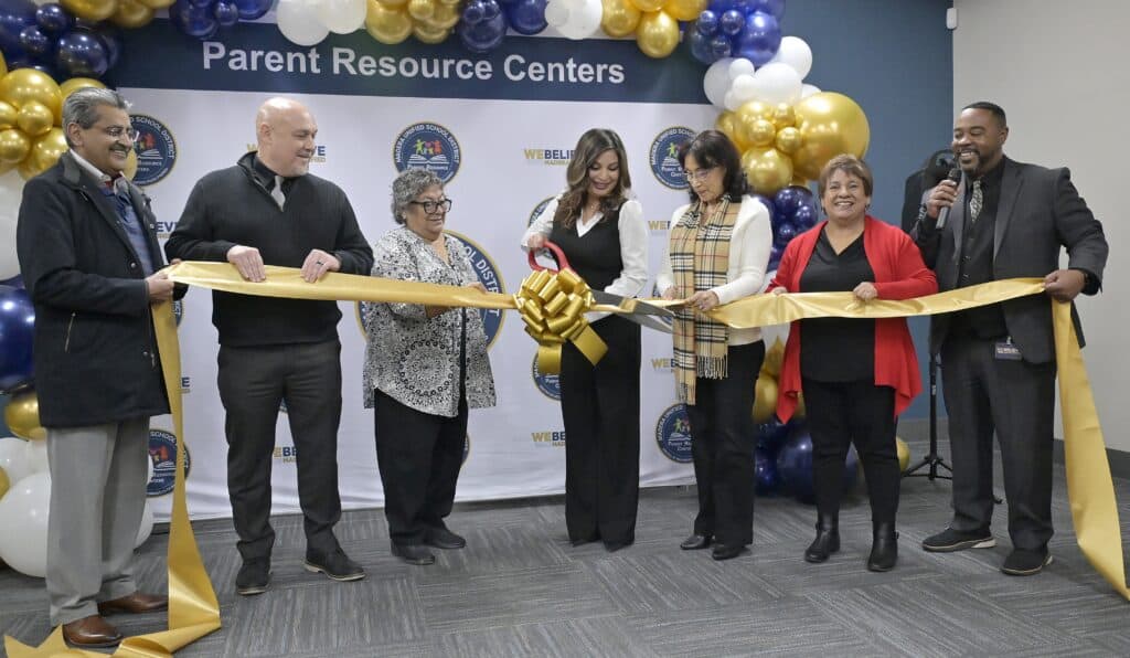 Photo of the Madera Unified School District officials gather for a ribbon cutting ceremony for the opening of MUSD’s newest Parent Resource Center on Thursday at 2055 W. Cleveland Avenue, Suite C. Elia Medina, center holding scissors, is joined by district representatives from left, board member Nadeem Ahmad. Superintendent Todd Lile, board member Joetta Fleak, board member Gladys Diebert, board member Lucy Salazar and Prince Marshall.