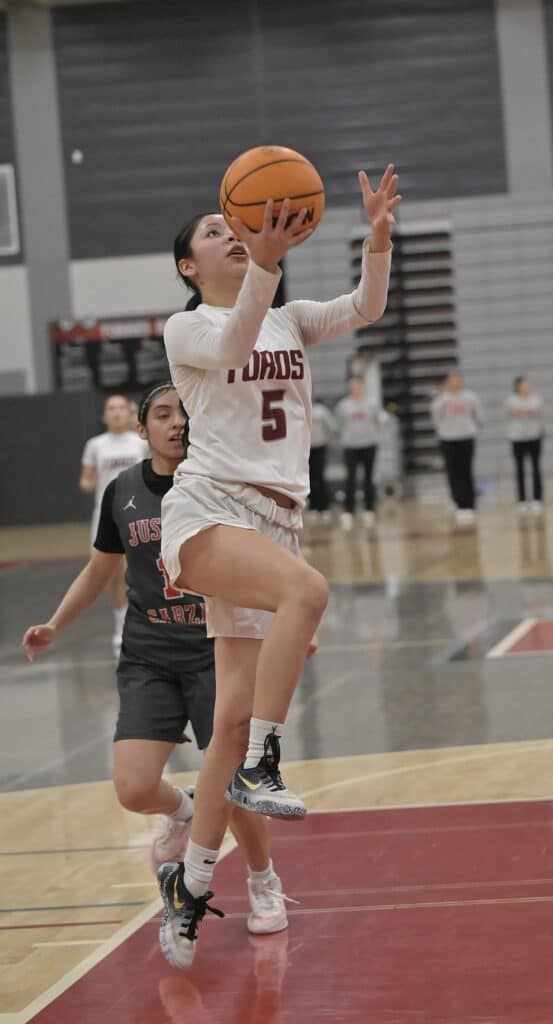 Photo of Matilda Torres’ Kaylin Perez drives in for a layup for two of her team-leading 18 points in Wednesday’s playoff victor over Justin Garza. 