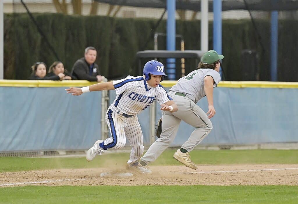 Photo of Madera's Ray Urbano jumps off the third base bag after a stolen base attempt in the fifth inning. The threw went into left field to allow Urbano to score the go-ahead run in Tuesday's win over El Diamante.