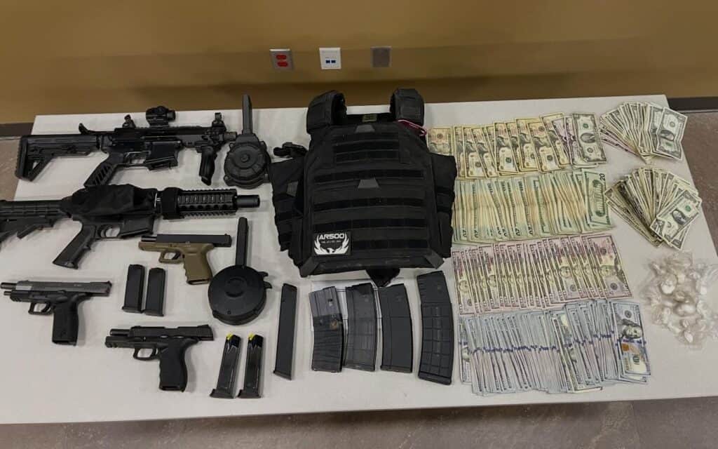 Photo - The Madera County Sheriff’s Office executed a search warrant Thursday on a suspected indoor marijuana cultivation operation inside a shop. Deputies seized two AR-15 rifles, three handguns, multiple rounds of ammunition, a body armor vest, more than $18,000, in addition an an ounce of cocaine and 9.5 pounds of processed marijuana.