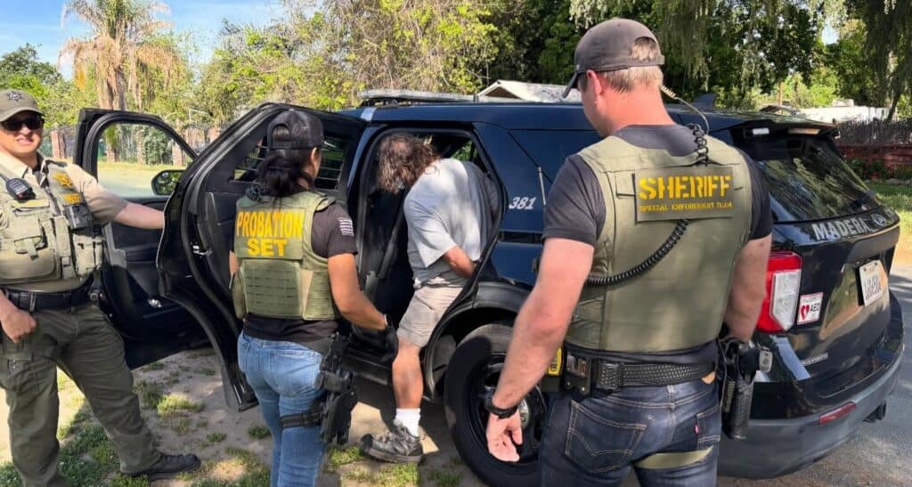 Photo of A member of the Madera County Sheriff’s Special Enforcement Team makes an arrest on a burglary suspect after vehicles were reported broken into in the Riverstone community.