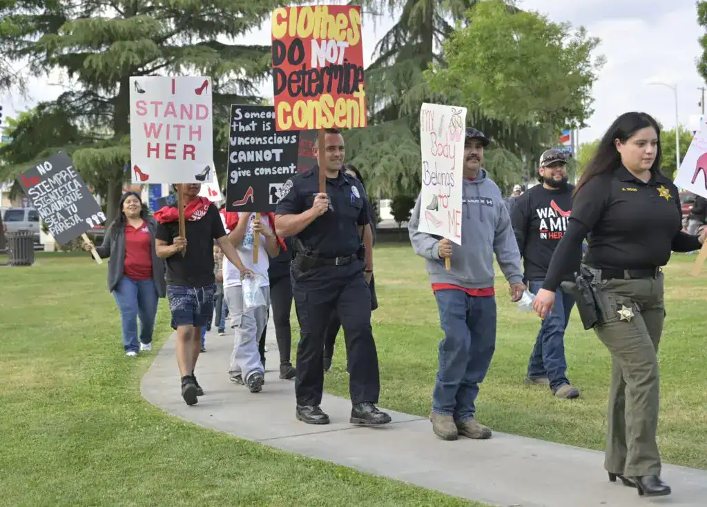 Photo - Participants finish the final lap during the annual Walk A Mile In Her Shoes march against sexual assault at Courthouse Park last year. The event is hosted by CAPMC Victim Services.