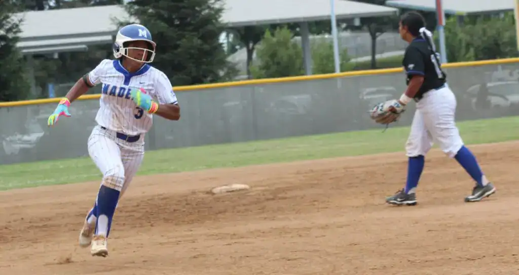 Photo - Madera’s Malea Ricks flies into third base en route to an inside-the-park home run in the first inning of Tuesday’s Easter Classic win over Clovis.
