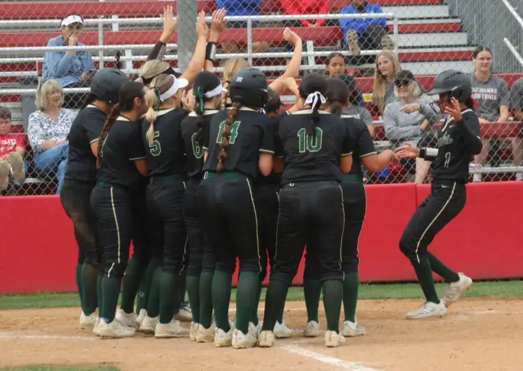 Photo - Liberty’s Carly Jimenez is greeted by her team after hitting a three-run home run in Tuesday’s tournament loss to Buchanan. 