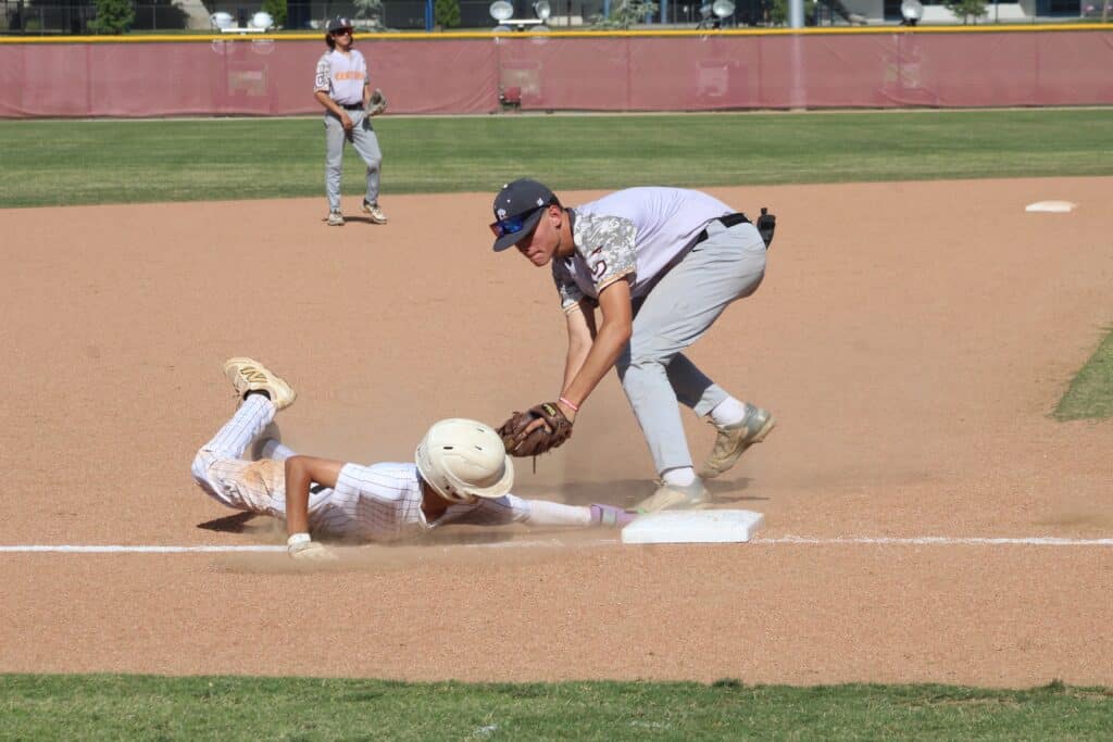 Photo - Matilda Torres’ Austin Meza slides under the Central third baseman’s tag on a third inning stolen base in Friday’s win. The lead-off batter was on base all three times with a hit, walk and hit by pitch. He also scored a run with two stolen bases.