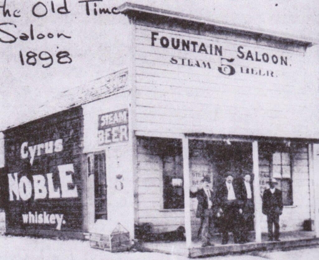 Photo - The Fountain Saloon was located at Gateway and Yosemite. George Gruber, the owner, is shown here, second from the left.