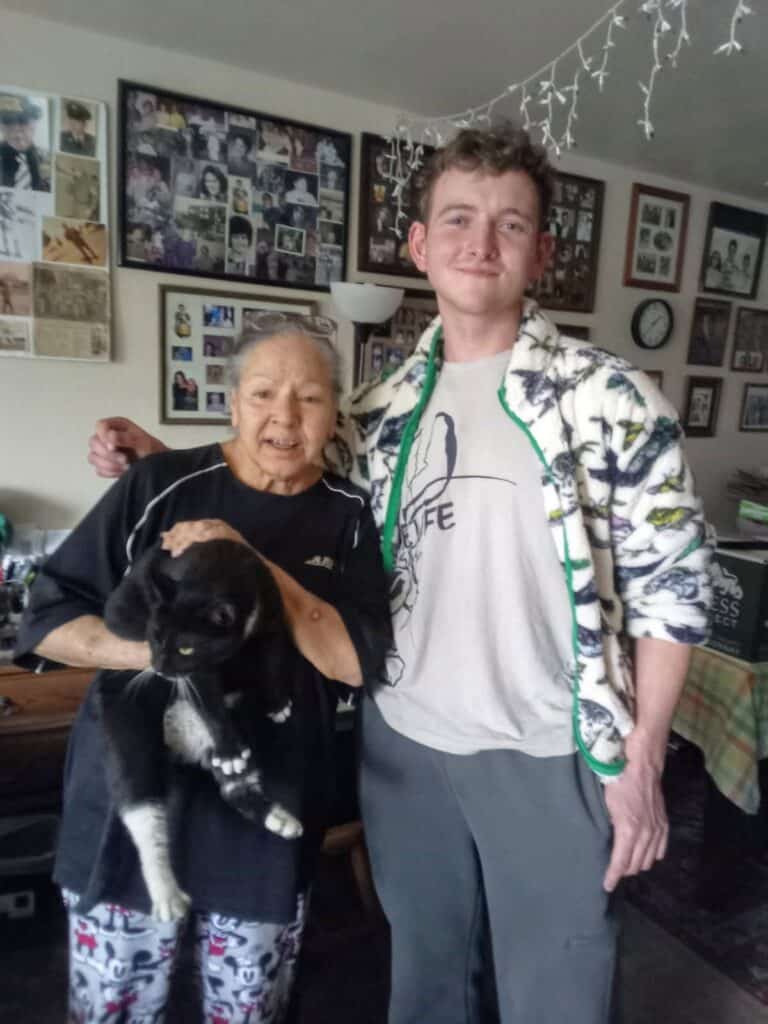 Photo - Vicki Pratt, holding Chiquita, poses with Michael Israel, of High Country Humane. Chiquita was reunited with Pratt after having gone missing for six months.