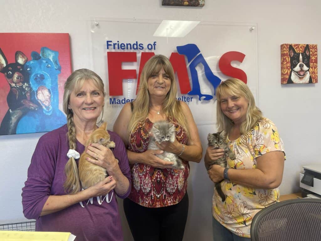 Photo - From left are FMAS Board Member Kirsten Gross (holding Bobby), Diana Frazier (holding Simpson), and Becky Koop (holding Lucien).