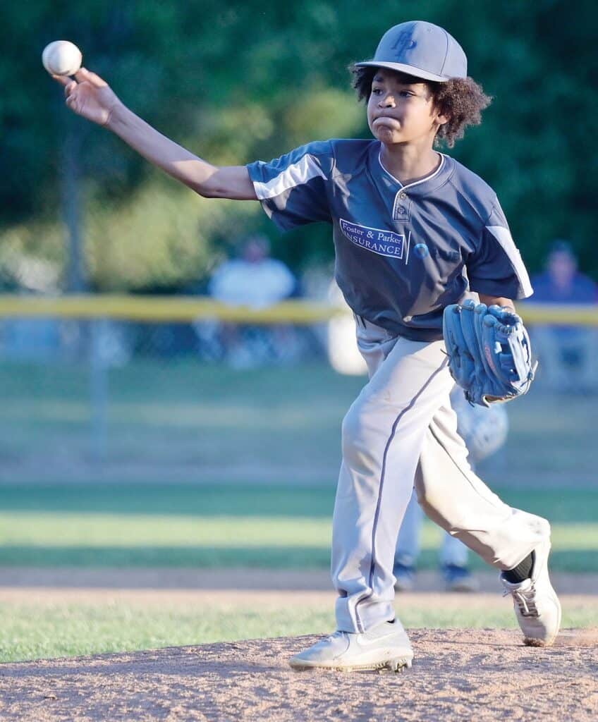 Photo - Foster and Parker’s Monte Moore throws a pitch during Tuesday’s District 10 Tournament of Championship game against Morgan’s Garage. Moore picked up a three-inning save in the 7-5 win. He allowed an unearned run on two hits with five strikeouts.