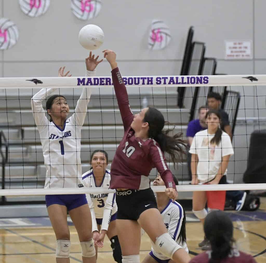 Madera South volleyball player spikes ball against Stallions.