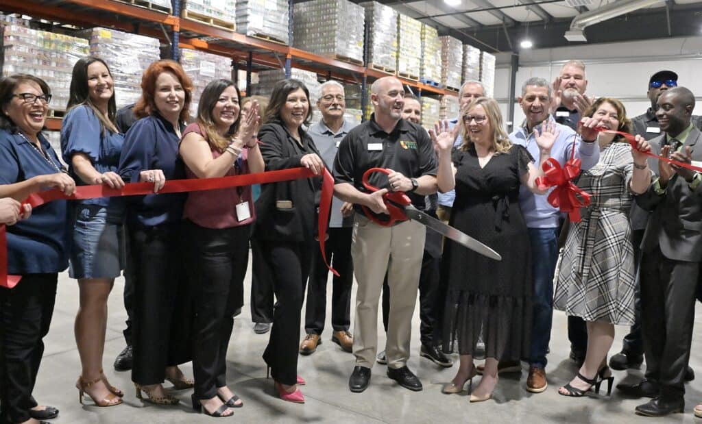Community members and officials at the Madera Food Bank ribbon-cutting event.