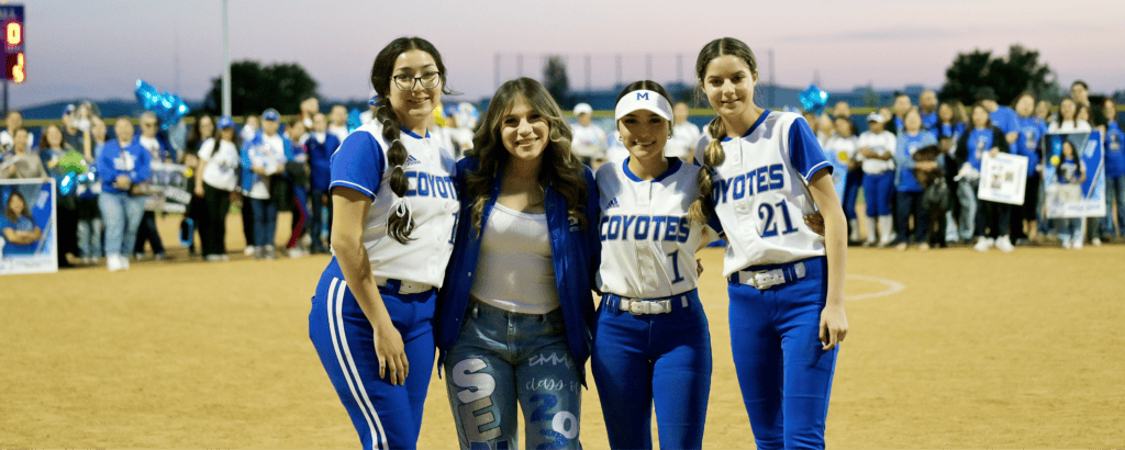 Madera Coyotes senior night with players and fans celebrating on the field.