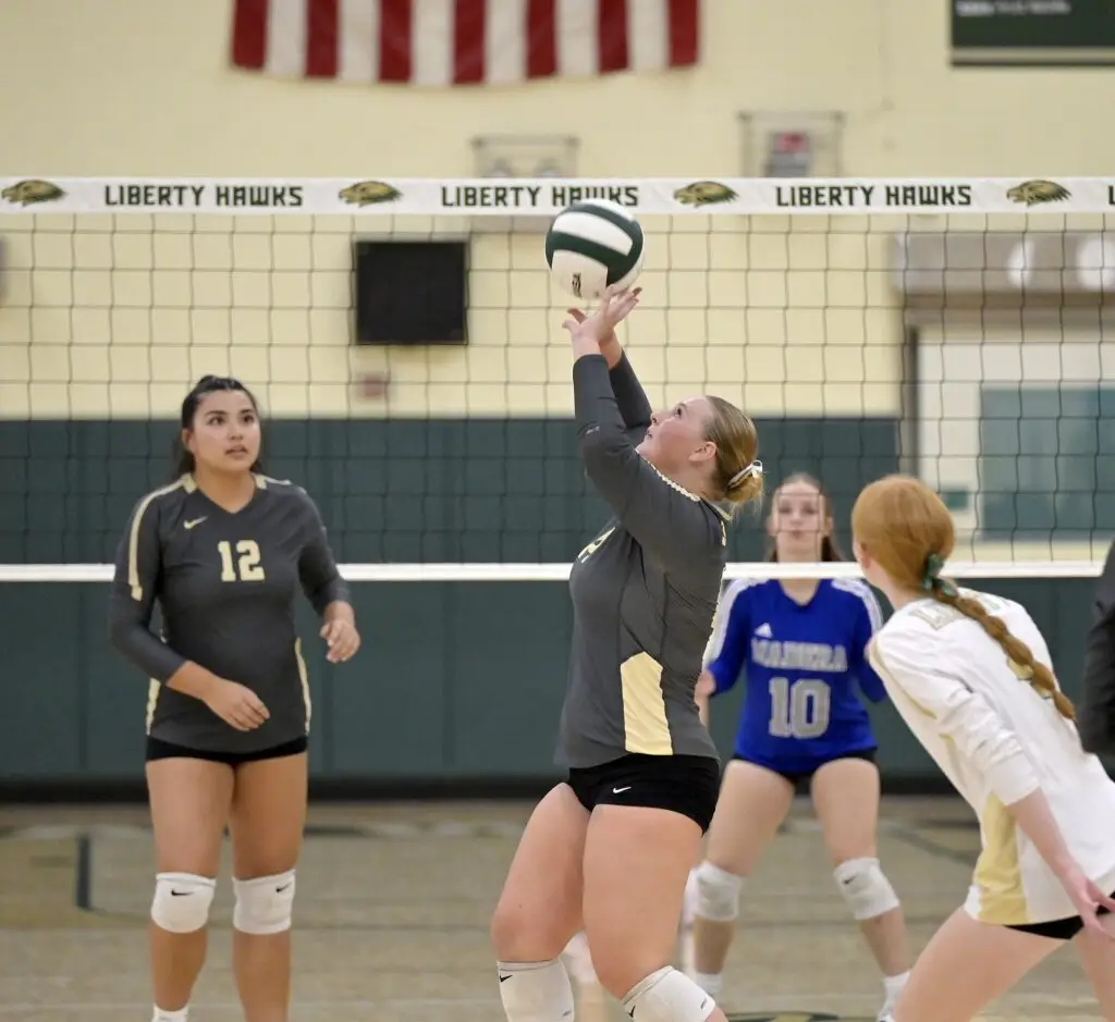Photo - Liberty setter Allison Wolf starts the offense for the Hawks during Tuesday’s three-set sweep over the Madera Coyotes. Wolf also added four kills to the 38 kills by the Hawks.