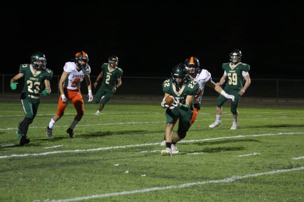 Madera High football team scores a touchdown during a night game.