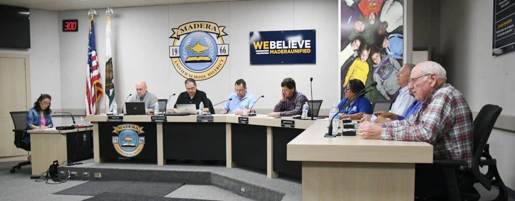 Madera County school board members during a meeting in a conference room.