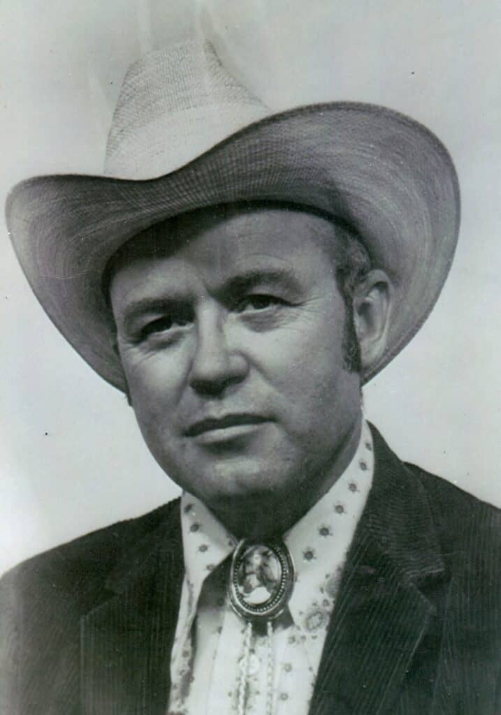 Portrait of Sheriff Bates wearing a cowboy hat and bolo tie, celebrating his 95th birthday.