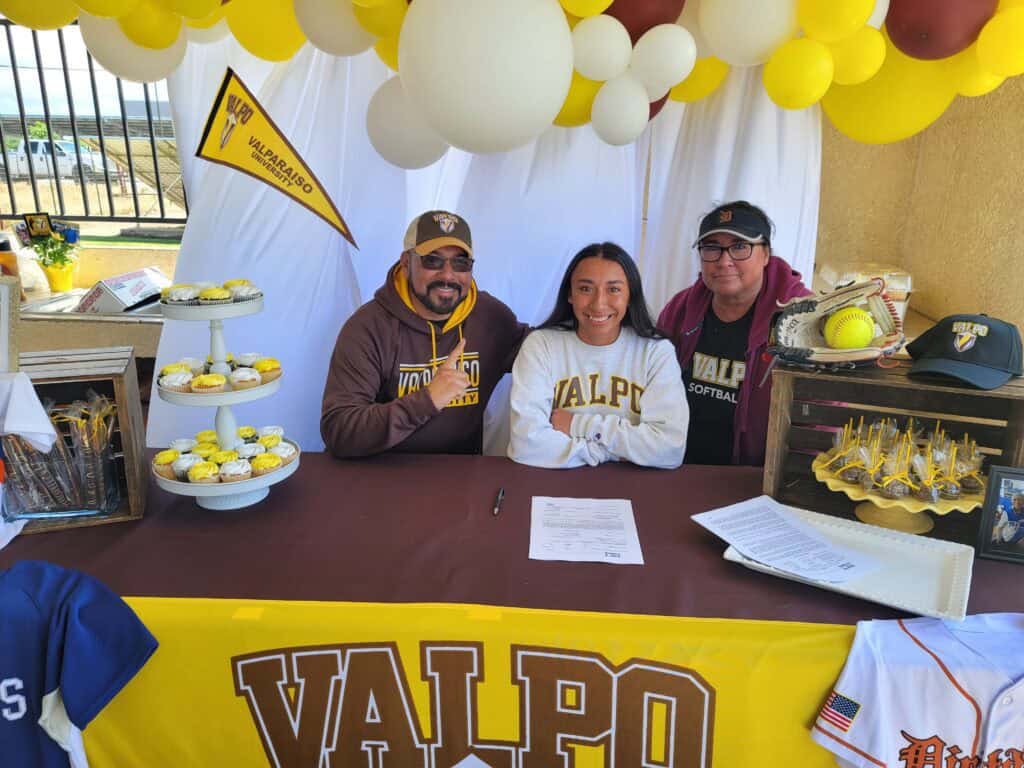 Softball player Perez signs with Valparaiso Div. I at Madera Tribune event.