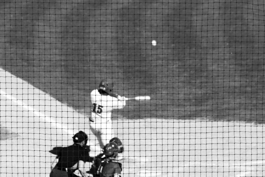 Madera Bulldogs batter hitting a pitch during a game.
