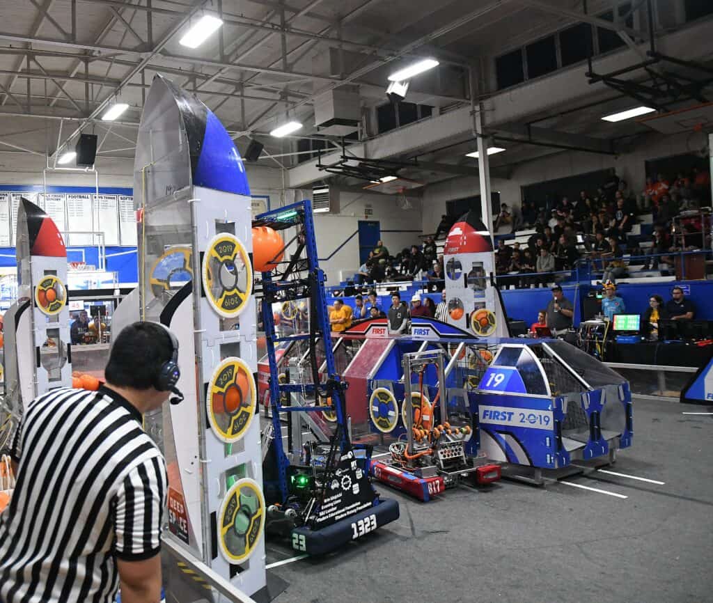Robotics team competes at MadTown Robotics event, showcasing innovative designs and teamwork in a hi.