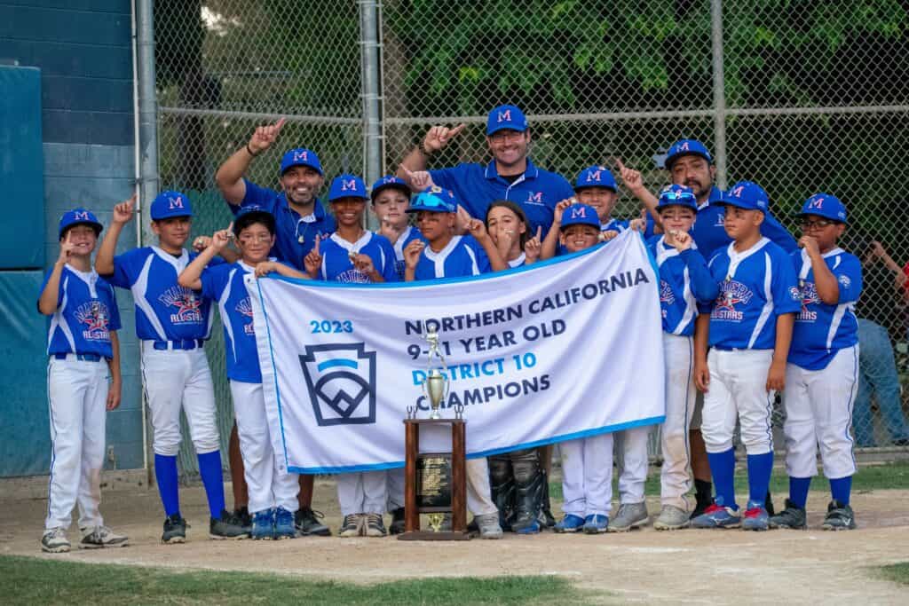 Madera National 11s youth baseball team celebrating victory.