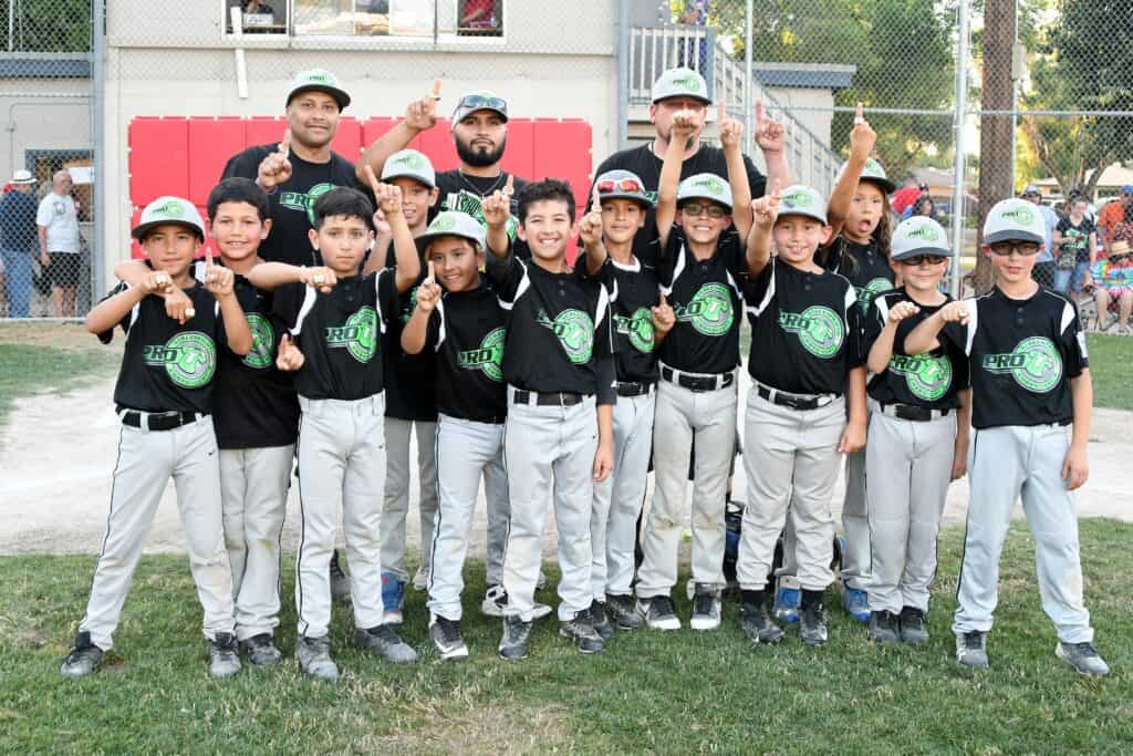 Madera Pro T’s youth baseball team celebrating victory after AAA championship game.