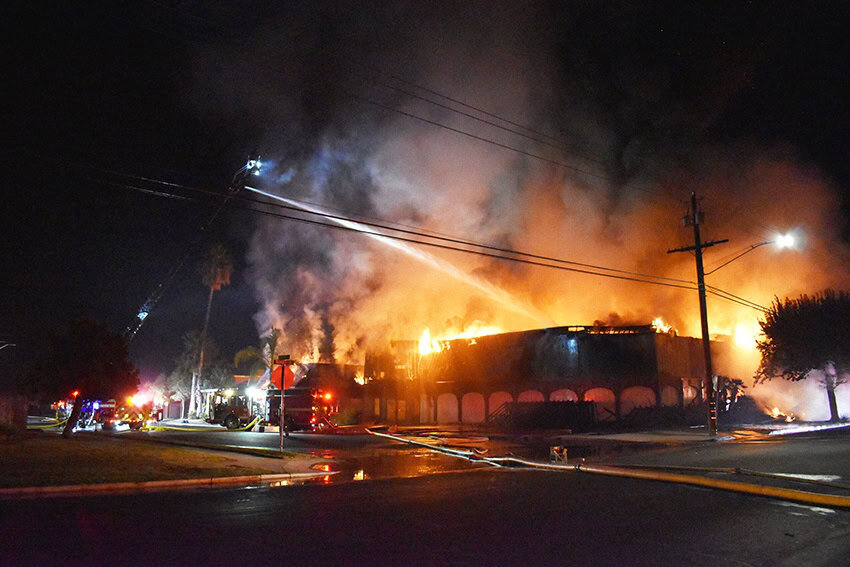 Fire consumes iconic Madera Athletic Club building during night blaze.