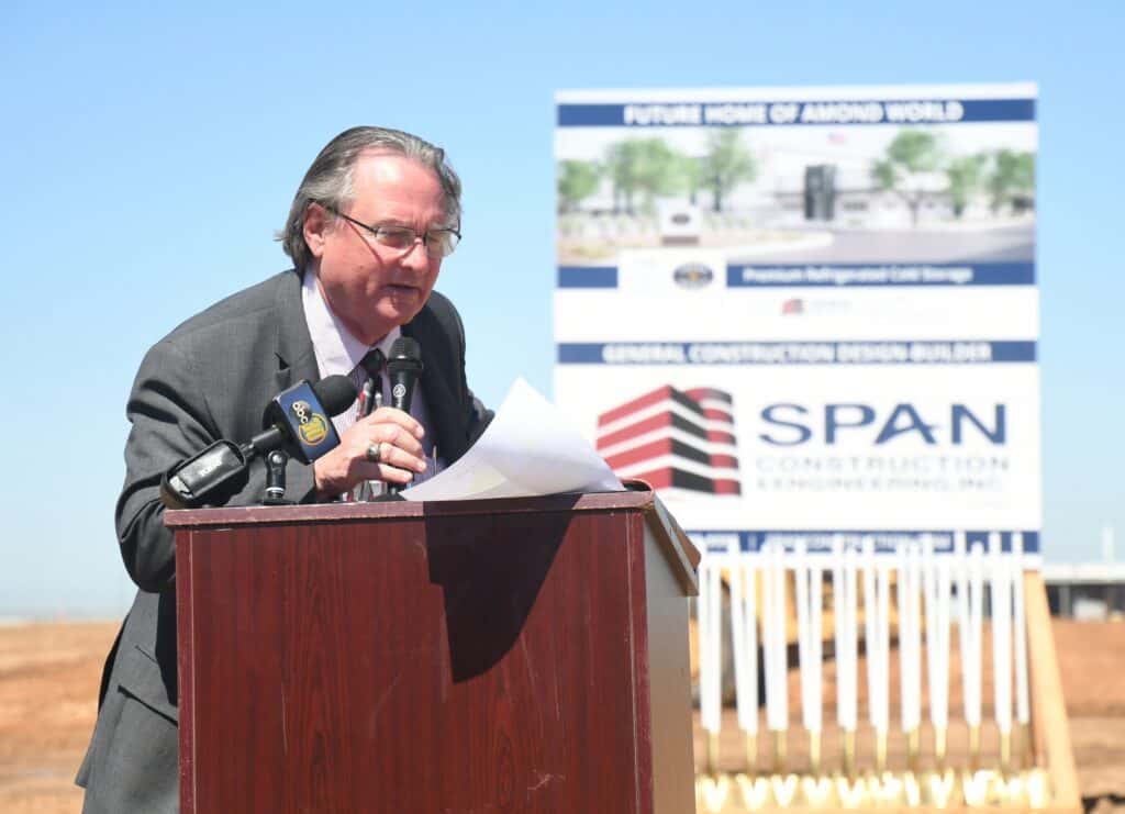 EDC director speaking at outdoor event about retirement plans.