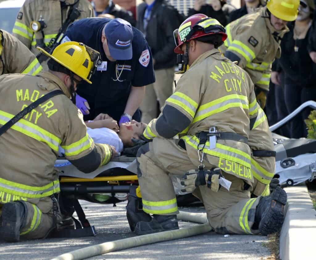 Madera firefighters provide emergency aid at a vehicle accident scene.