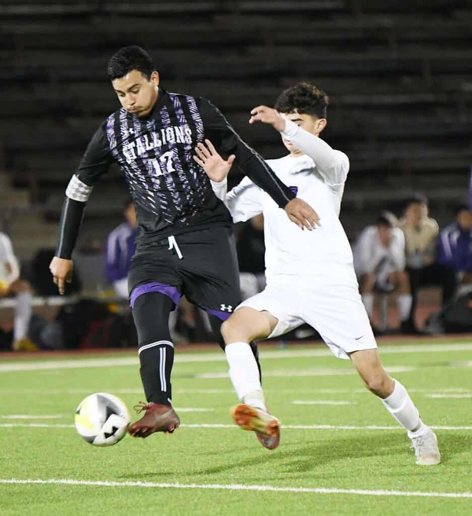 Young soccer players competing in a match at Madera high school.