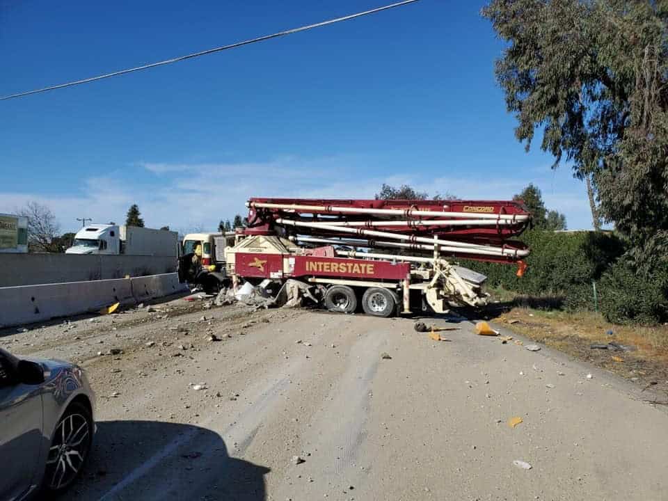 Accident blocks SR99 traffic involving a large construction vehicle and debris on the road.