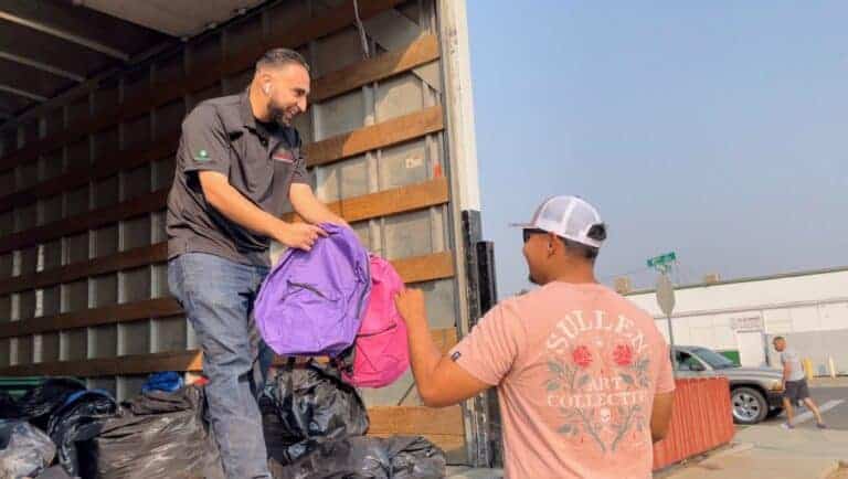 Pacific Farm Management hands out backpacks