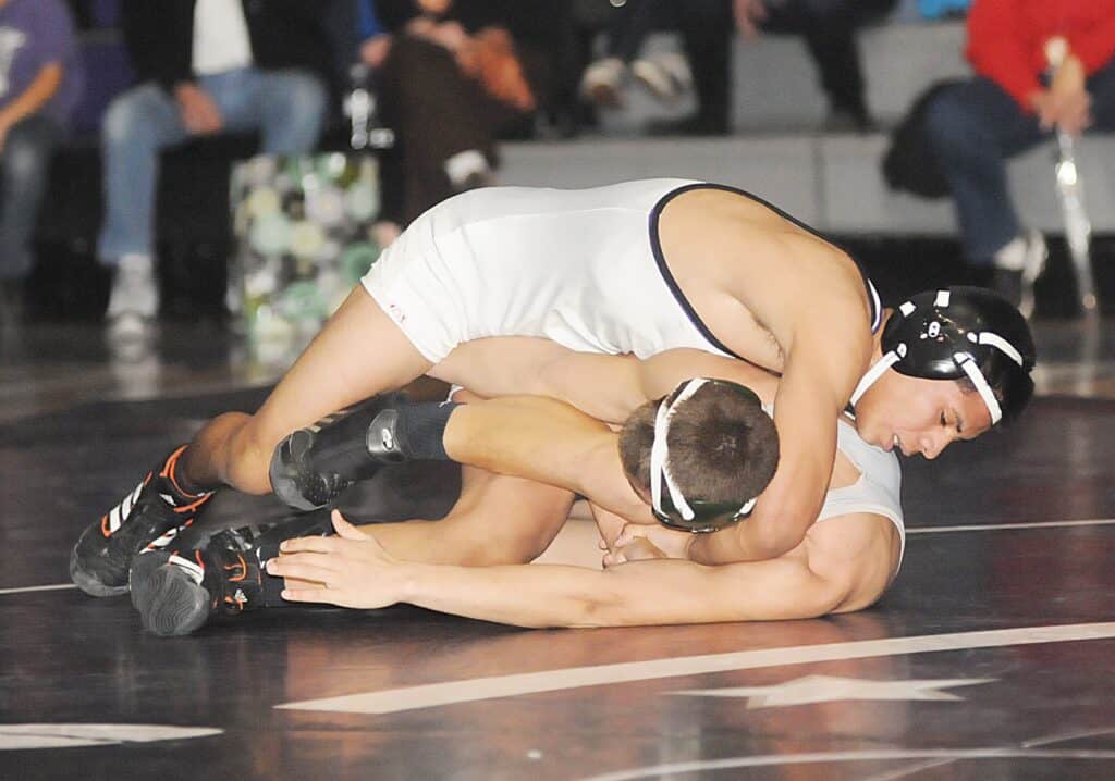 Wrestlers in action during a match at Hernandez earns state medal competition.