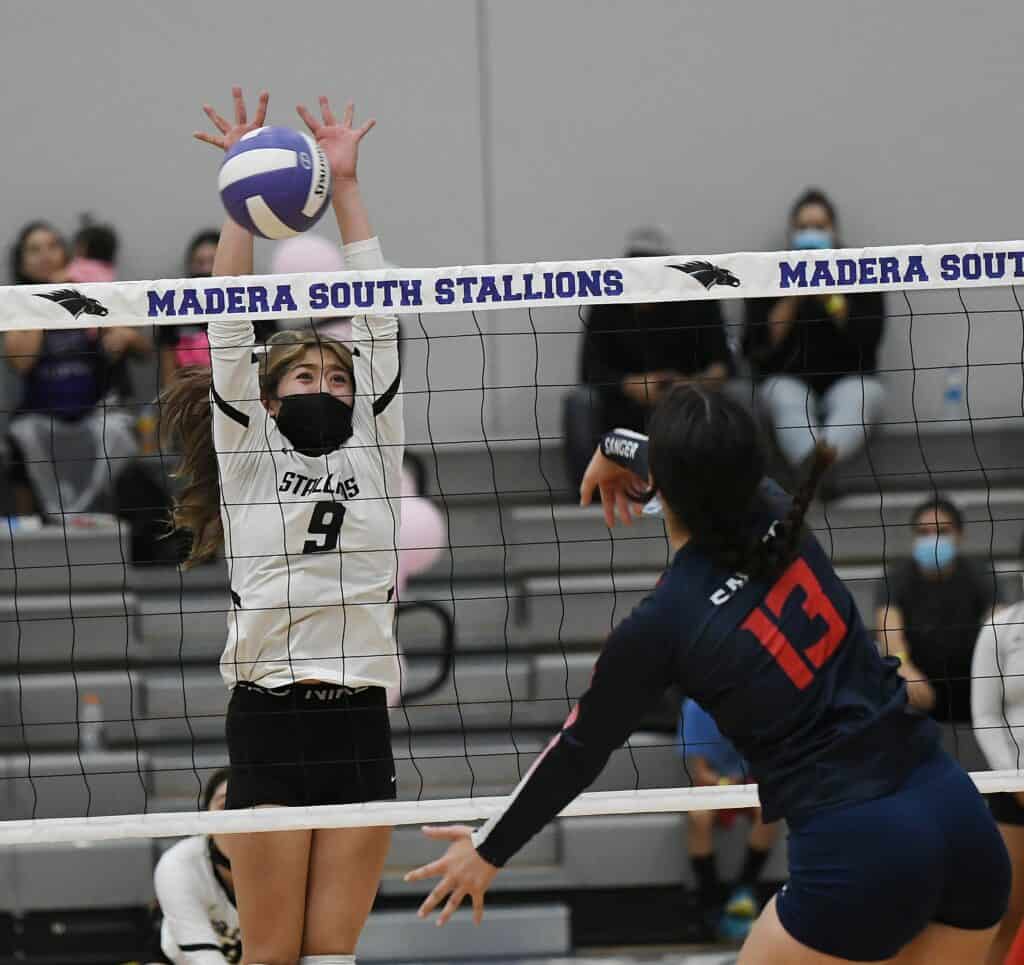 Madera South Stallions volleyball player blocking at the net during a match.