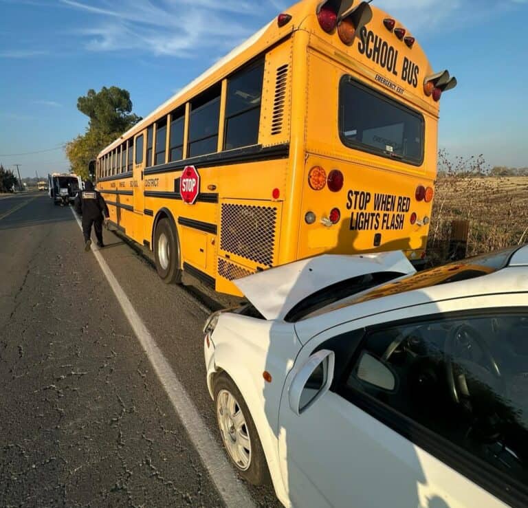 Car hits school bus, no serious injuries