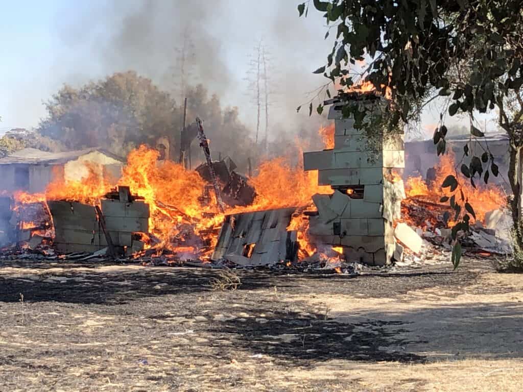 Fire consumes abandoned house in Madera, with thick smoke and intense flames visible. No injuries re.