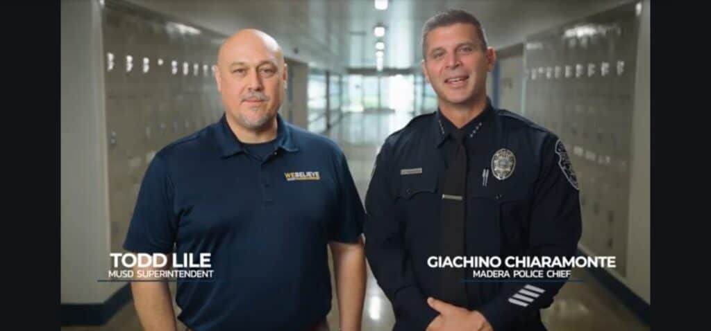 Madera Unified School District staff members Todd Lile and Giachino Chiaramonte in school hallway.