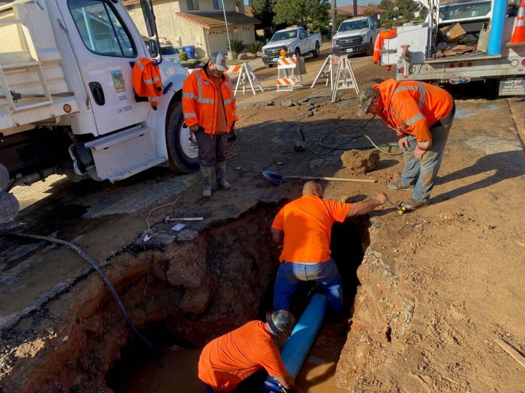Workers installing water pipes during community water project in Madera.