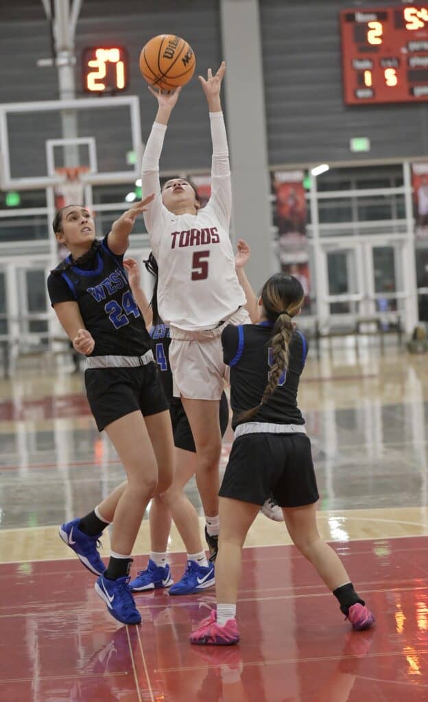 Photo - Matilda Torres’ Kaylin Perez drives the lane to score two of her 12 points in Monday’s victory over the Sanger West Hornets.