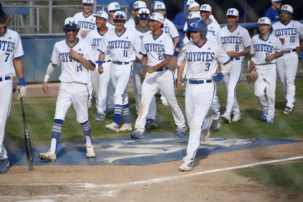 Madera Coyotes baseball team celebrating after a game victory.